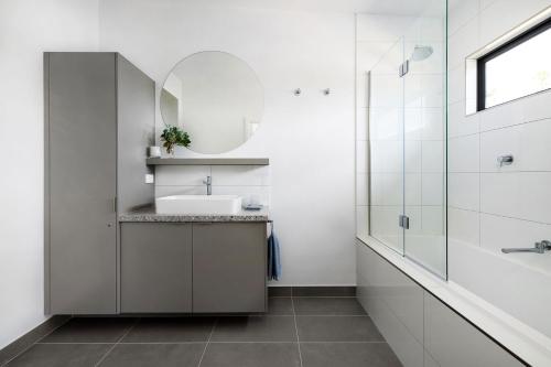 a bathroom with a sink and a mirror at Banksia Villa in Eganstown