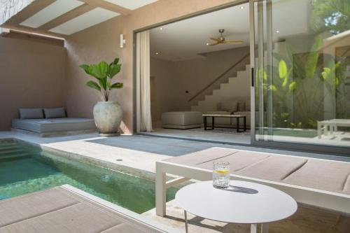 a house with a swimming pool and a table at Cielo Boutique Hotel & Spa Samui in Bophut 