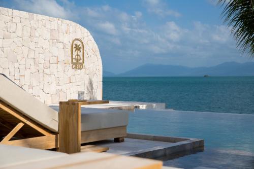 a resort with a swimming pool next to the ocean at Cielo Boutique Hotel & Spa Samui in Bophut 