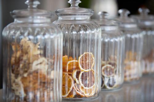 a row of glass jars with orange slices in them at Cielo Boutique Hotel & Spa Samui in Bophut 