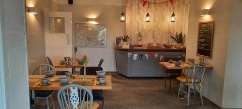 a restaurant with tables and chairs and a counter at Seals Bacton in Bacton