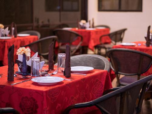 a table with red table cloths and utensils on at HOTEL CENTRAL PARK & CONFERENCE CENTRE in Nairobi