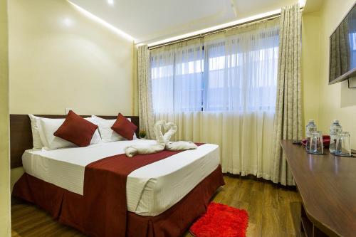 a bedroom with a large bed with a window at HOTEL CENTRAL PARK & CONFERENCE CENTRE in Nairobi
