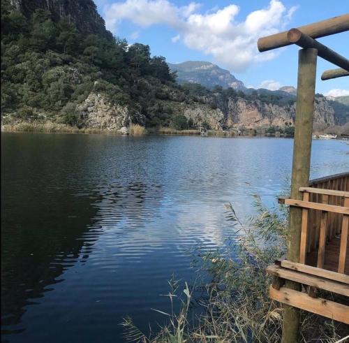 a view of a lake with mountains in the background at Kamarca House Hotel in Ortaca