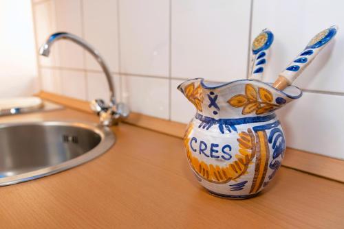 a pot on a counter next to a sink at Sidar-Old Town in Cres
