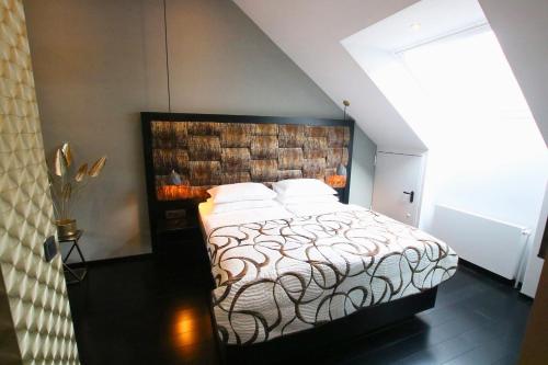 a bedroom with a large bed with a wooden headboard at Hotel Vienna beim Prater in Vienna