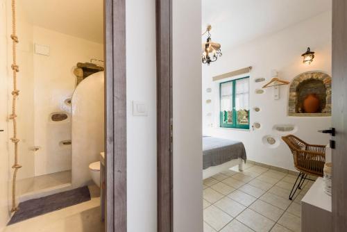 a bathroom with a sink and a toilet in a room at seaside Ktima KaParos PAROS in Drios