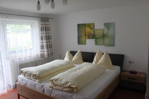 a bedroom with two beds with white pillows at Schattwalder Hof in Schattwald
