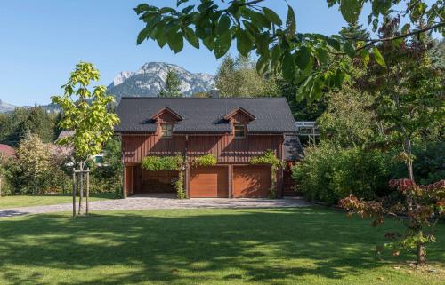 a house with a garage in a yard at Landhaus Alte Salzstraße - Your Austrian Home in Bad Aussee