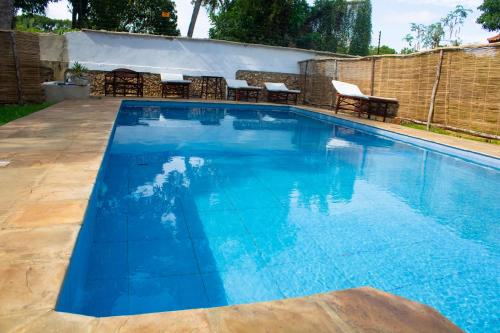 a large swimming pool with blue water at Cycad Palm Diani in Diani Beach