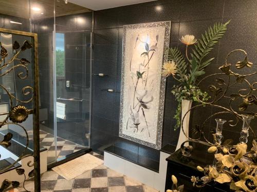 a bathroom with a shower with a glass door at Lanshan Guest House in Taitung City
