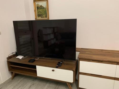 a large flat screen tv sitting on a wooden entertainment center at Lanshan Guest House in Taitung City