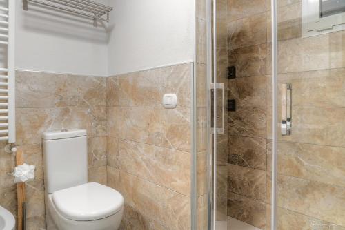 a bathroom with a toilet and a glass shower at Hotel Cosmos in Florence