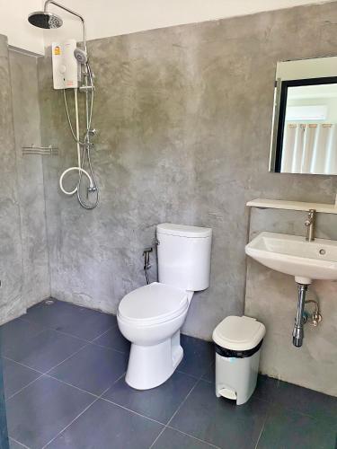 a bathroom with a toilet and a sink at The moon camp khanom in Ban Plau