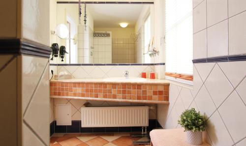 a bathroom with a sink and a mirror at Ferienwohnung Waldblick Nr. 11 in Kühlungsborn