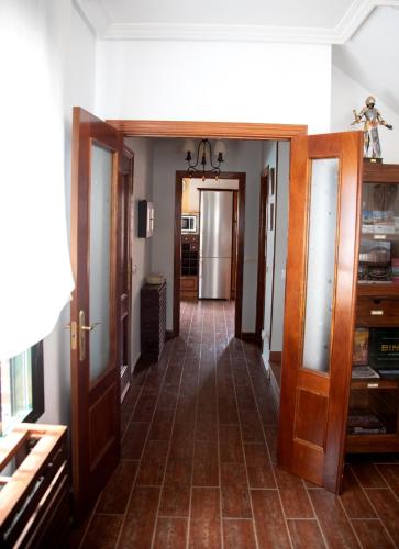 a hallway with doors and a tile floor at TOLEDO ENCANTADO Piscina y BBQ privada 2,5 km de Puy du Foy in Argés