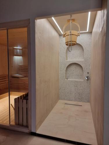 a hallway with a glass door and a light fixture at Orik Hotel & Spa in Vlorë