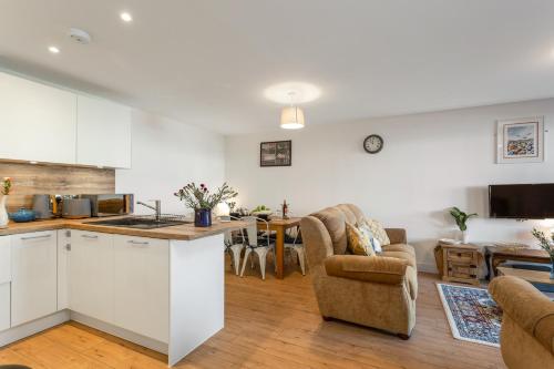 a kitchen and living room with white cabinets at Host & Stay - Farrier William in Margate