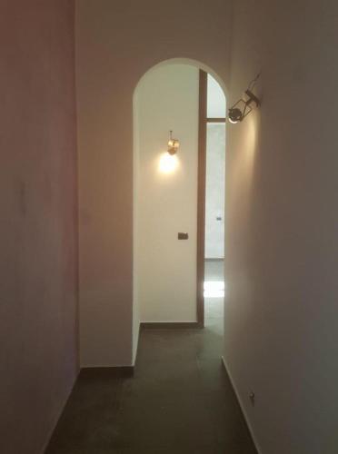 a hallway with a white door and a light at Agriturismo La Fornace centro ippico in Como