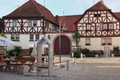 a building with a playground in front of it at Ferienwohnung Seidenfaden in Karlstadt