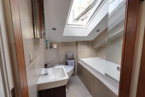 a bathroom with a sink and a skylight at Bretton House Farm Retreat in Chester