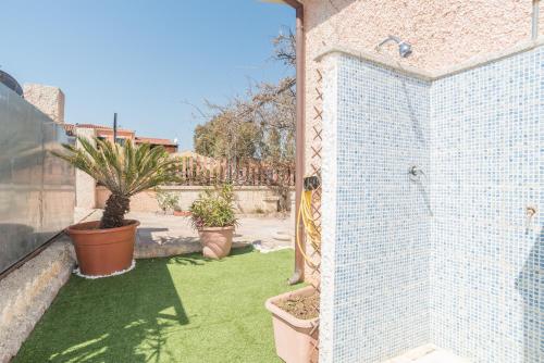 an open door to a yard with plants and grass at Villa Marisa in Budoni