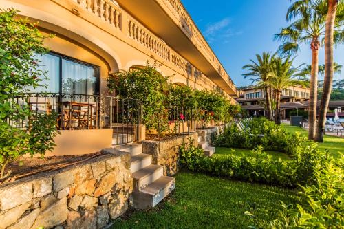 una casa con una pared de piedra y escaleras en Mon Port Hotel & Spa, en Puerto de Andratx