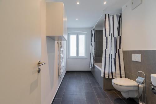 a bathroom with a toilet and a sink at Nena Apartments Hermannplatz in Berlin