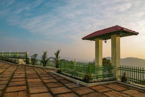 a fence with a gazebo on top of a hill at Belle Bonami Resort in Vagamon