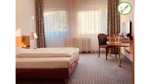 Postel nebo postele na pokoji v ubytování Akzent Congresshotel Hoyerswerda