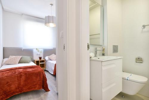 a white bathroom with a bed and a sink at 215 Penthouse SPA GOLF - Alicante Holiday in Villamartin