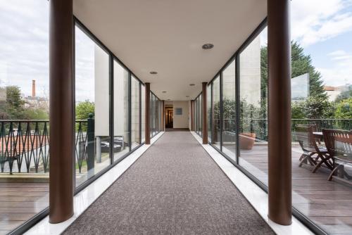a corridor of a building with large windows at Eurostars das Artes in Porto