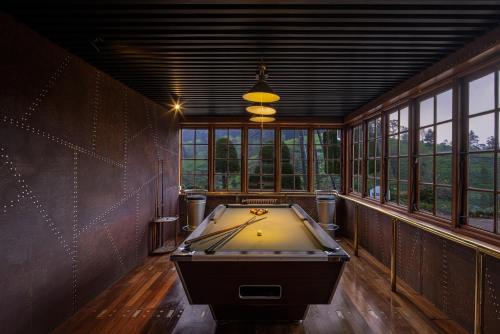 
a bath room with a tub and a bench at Heritance Tea Factory in Nuwara Eliya
