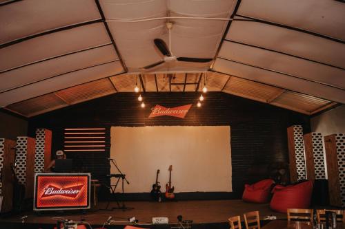 a room with a stage with a white screen at Pretorius Park in Hartbeespoort