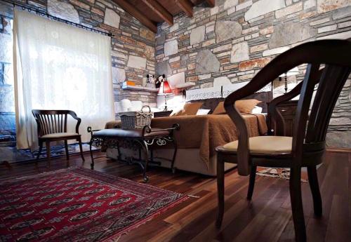 a bedroom with a bed and a stone wall at Kamarca House Hotel in Ortaca