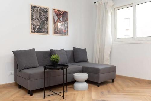 a living room with a couch and a window at grey l studio apartments Downtown Cairo Ouzonian House in Cairo