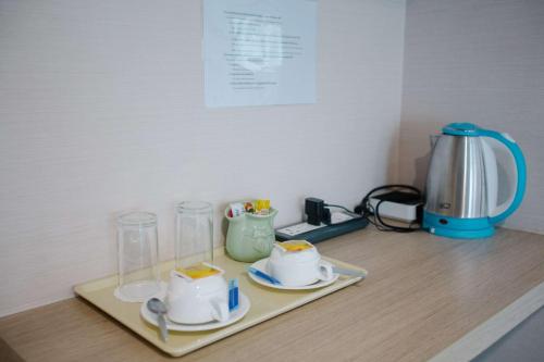 a counter with a tray with cups and a blender at Best Western Royal Buriram in Buriram