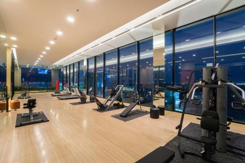 a gym with a view of the city at Best Western Plus Wanda Grand Hotel in Nonthaburi