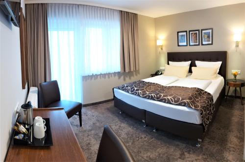 Кровать или кровати в номере Hotel Regina