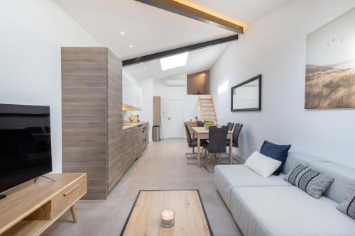 a living room with a couch and a table at Residence Meynadier - apartments - New - AC - Wifi - Close Beach and Palais - LRA Cannes in Cannes