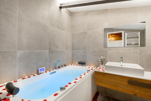 a bathroom with a large tub and a sink at Residence Meynadier - apartments - New - AC - Wifi - Close Beach and Palais - LRA Cannes in Cannes