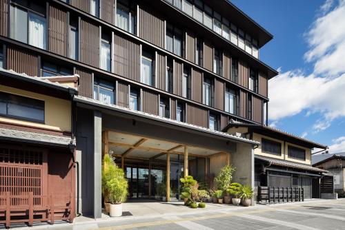 an office building with large windows and plants at NOHGA HOTEL KIYOMIZU KYOTO in Kyoto