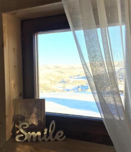 a window with a smile sign in front of it at Zlatiborski katuni in Zlatibor