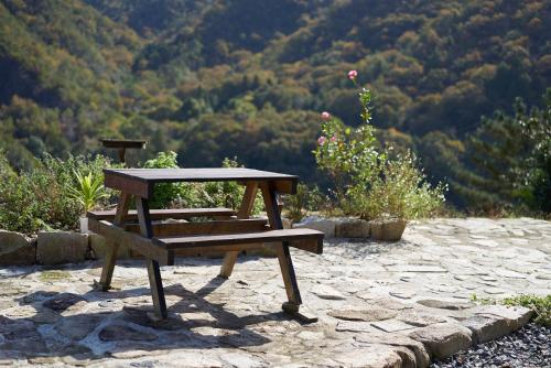 a picnic table and bench sitting on a stone patio at OldbutNew 蔵 in Hara