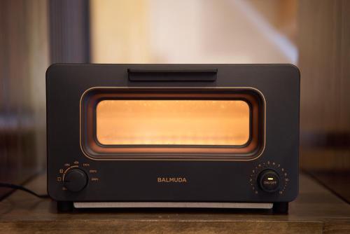 a black toaster oven sitting on top of a table at OldbutNew 蔵 in Hara