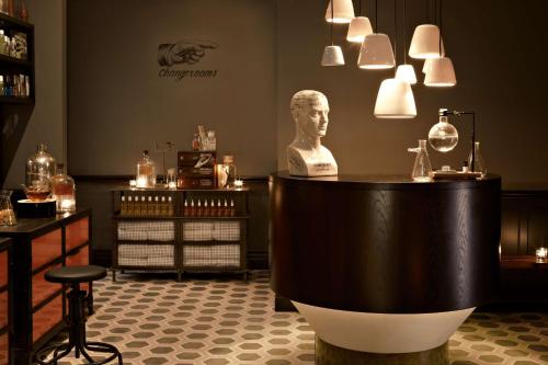 a room with a bust of a man on a table at QT Sydney in Sydney