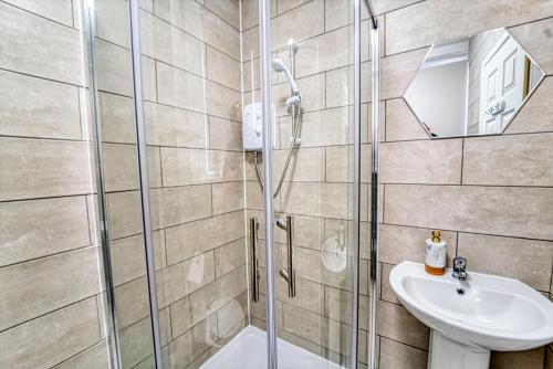 a bathroom with a shower and a sink at Guest Homes - New Street Residence in Worcester