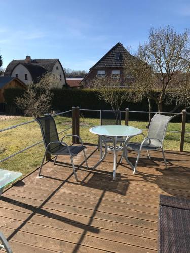 a table and two chairs on a wooden deck at Hinterhaus "Galgenbruch" in Feldberg