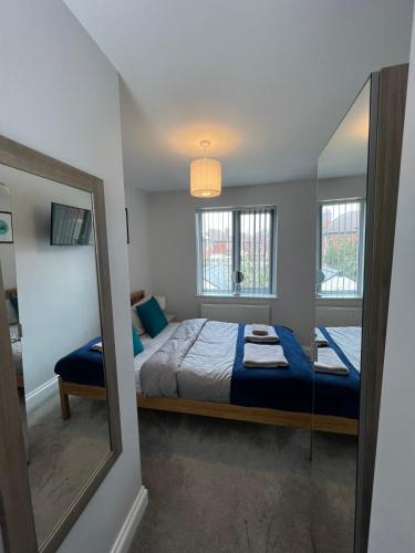 a small bedroom with a bed and a mirror at The Wootton House in Doncaster