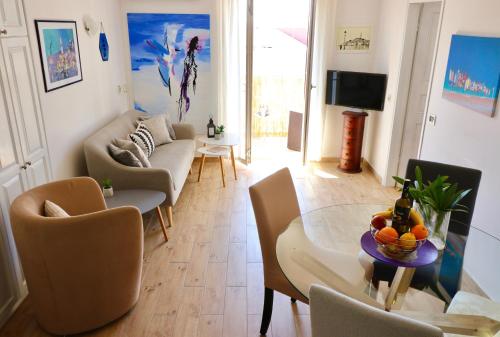 a living room with a couch and a table at Apartment Maestral in Rovinj